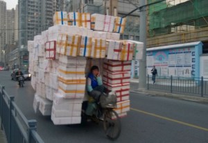 Yep-a bike on a busy street in Shanghai and she's talking on her mobile.