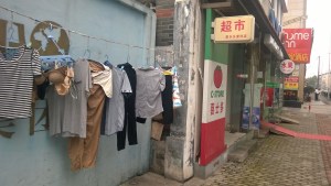 Sundays are laundry day and clothes are hung randomly all over the sidewalks to dry.