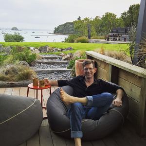 Thom celebrating his birthday relaxing in a beanbag on the beach